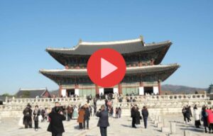 People visiting a traditional East Asian palace courtyard on a clear day.